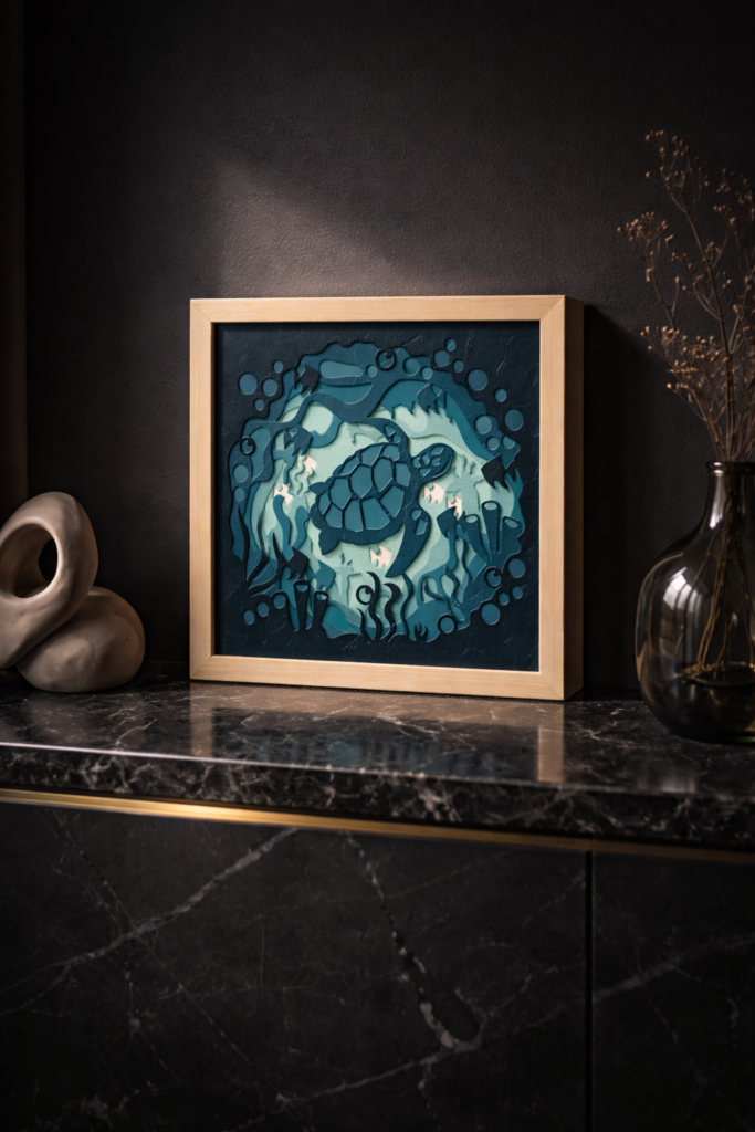 Layered sea turtle shadow box SVG framed artwork displayed in a modern dark interior on a marble console